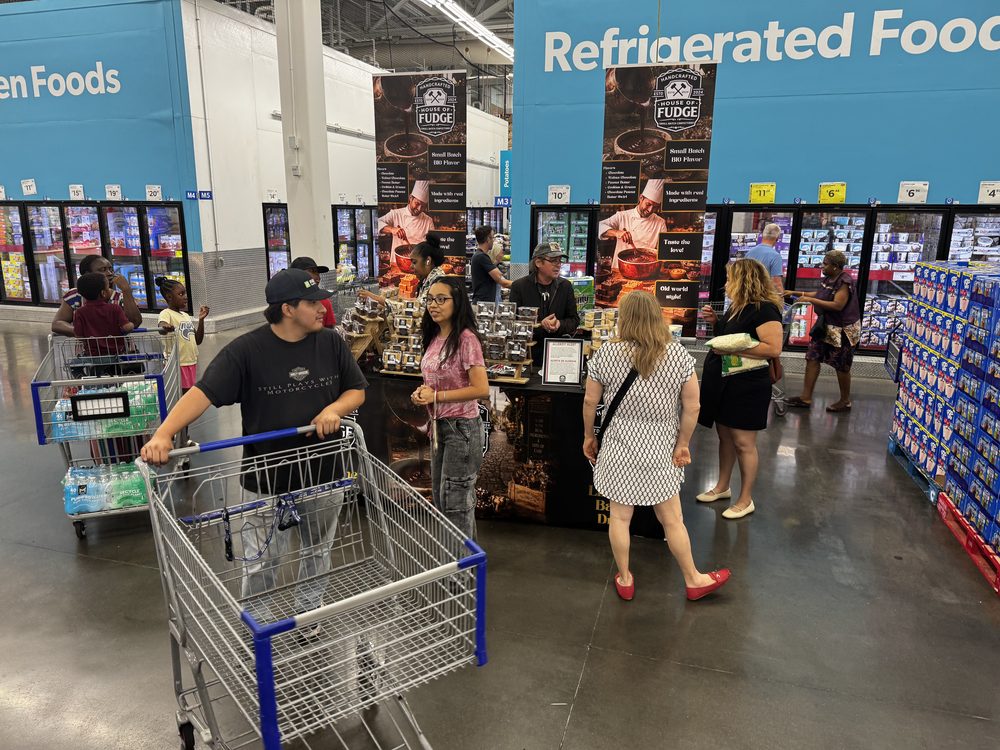 Shoppers with carts around the House of Fudge booth